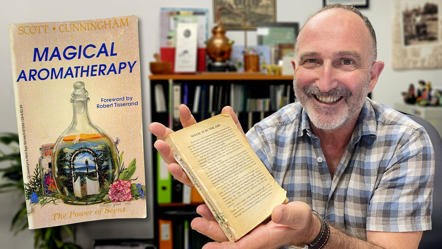 Salvatore Battaglia holding an old copy of Magical Aromatherapy